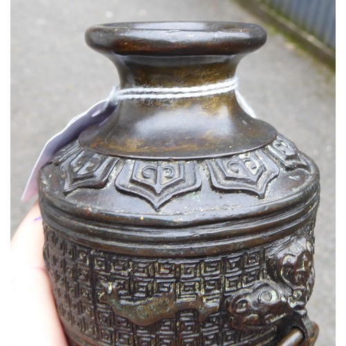 148 - A Chinese cast bronze vase of shouldered, tapered form with a narrow neck and flared rim, decorated ... 