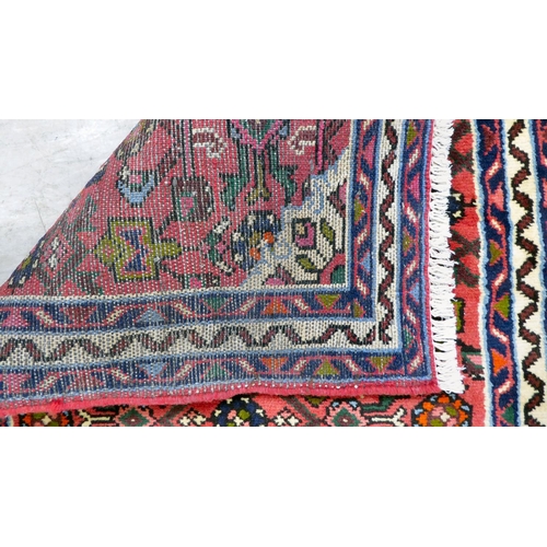 106 - A Persian design runner, decorated with floral motifs, on a red ground  78