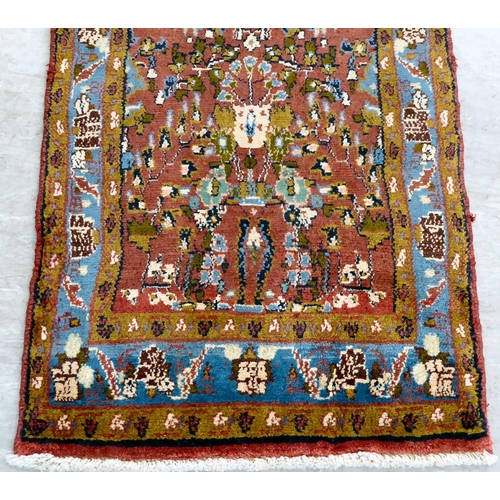 111 - A Persian design rug, decorated and bordered with floral motifs, on a red ground  78