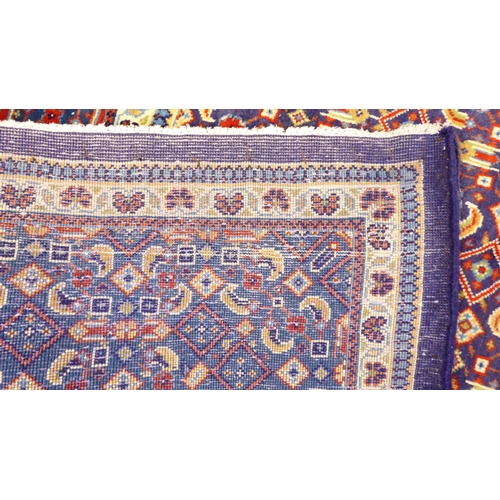 121 - A Persian design carpet, decorated and bordered with repeating geometric patterns, on a blue ground&... 