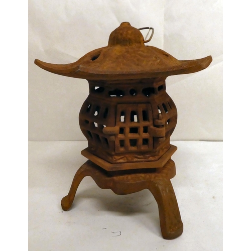 160 - A rust coloured cast iron, pagoda design tealight holder  8