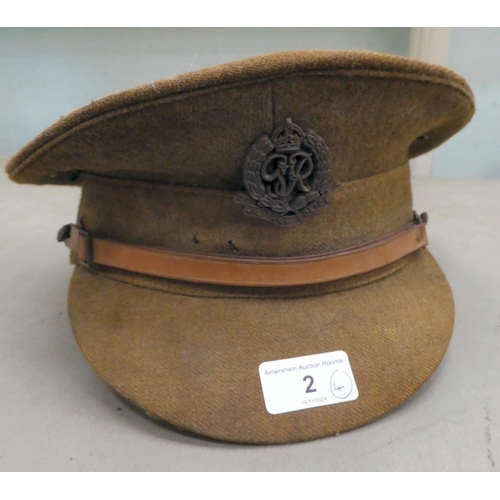 2 - Four helmets: to include one 'National Fire Service', and a fabric peaked cap with a military police... 