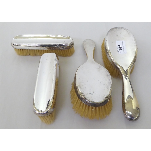 249 - A silver backed dressing table set, comprising two hair brushes and two clothes brushes  Birmin... 