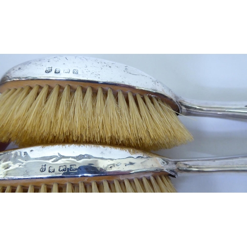 249 - A silver backed dressing table set, comprising two hair brushes and two clothes brushes  Birmin... 