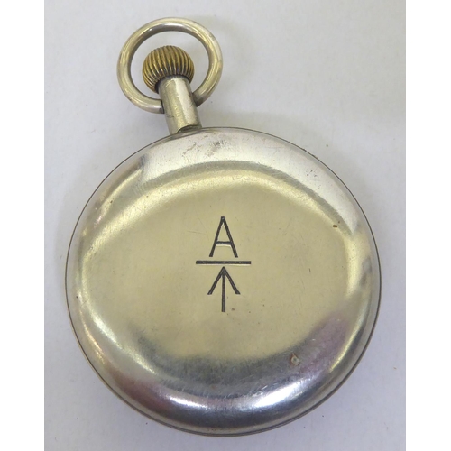 250 - A World War II military white metal cased pocket watch, faced by a black Arabic dial, inscribed 30 h... 