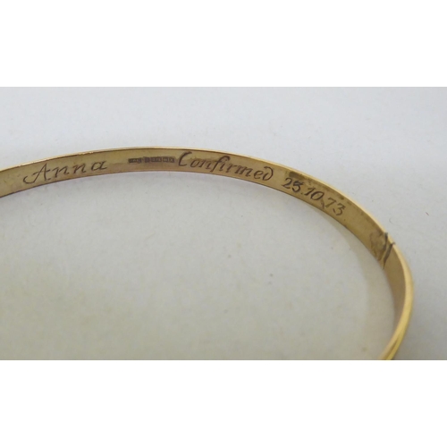 261 - A 9ct gold Christening bangle 