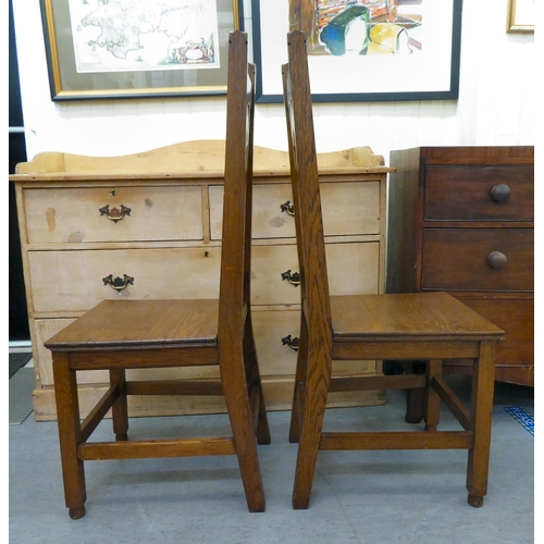 263 - A pair of late Victorian Arts & Crafts Pugin inspired, oak framed hall chairs, each with a caste... 