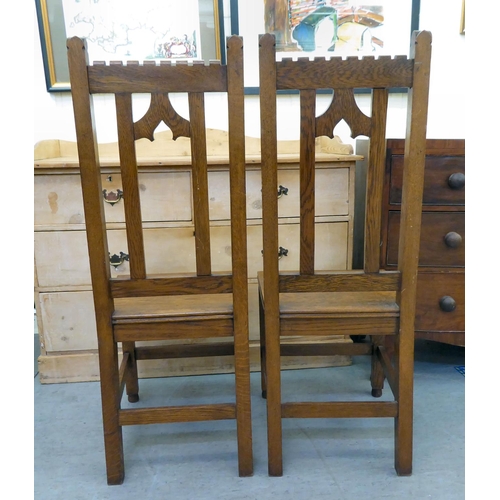 263 - A pair of late Victorian Arts & Crafts Pugin inspired, oak framed hall chairs, each with a caste... 