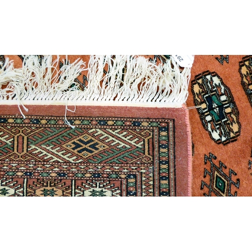 291 - A Turkoman rug, decorated with three columns of fifteen guls, on a red ground  52