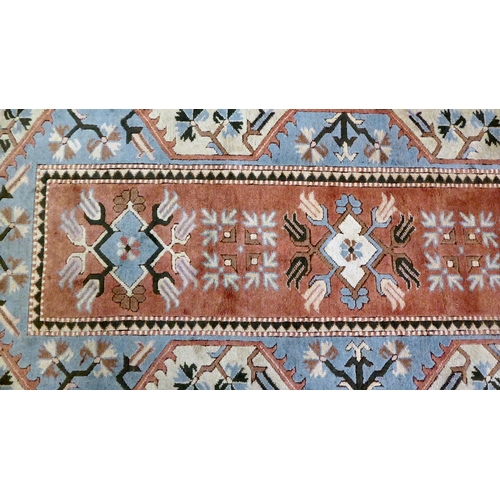 292 - An Oriental woollen rug, decorated with geometric designs, on a multi-coloured ground  76