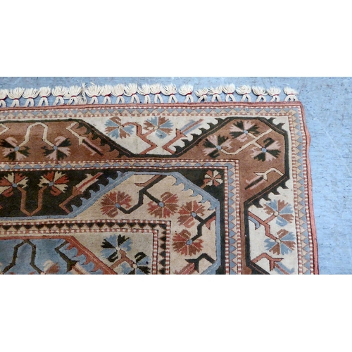 292 - An Oriental woollen rug, decorated with geometric designs, on a multi-coloured ground  76