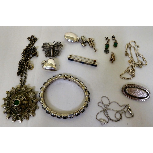 293 - Silver and white metal items of personal ornament: to include pendant charms  mixed marks