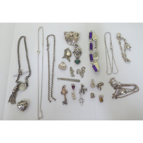 293 - Silver and white metal items of personal ornament: to include pendant charms  mixed marks