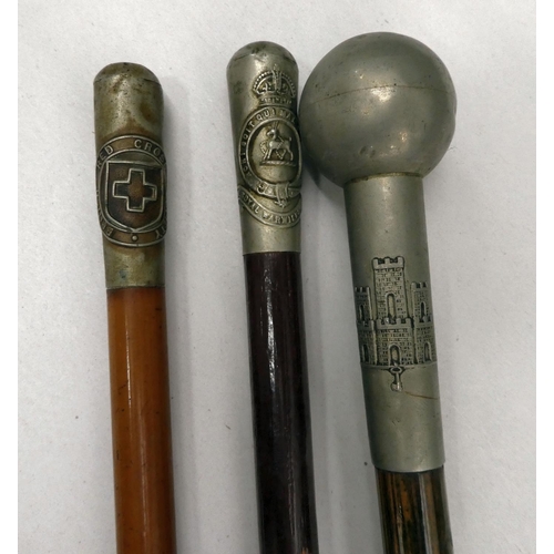 3 - Three swagger sticks, each with an individually themed cap: to include 'The British Red Cross Societ... 