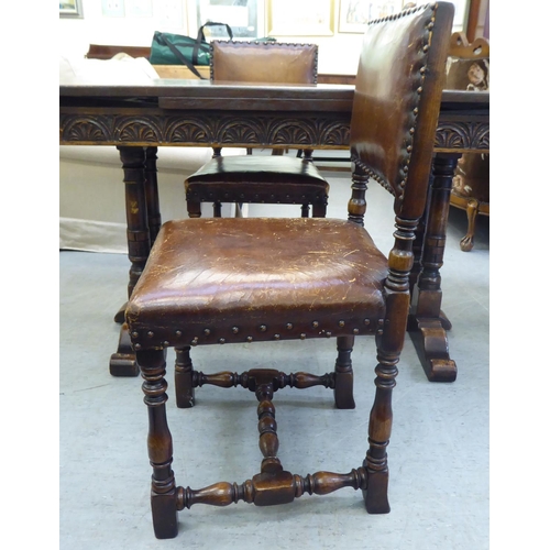 31 - An early/mid 20thC English style oak draw-leaf dining table, over a foliage carved frieze, turned an... 