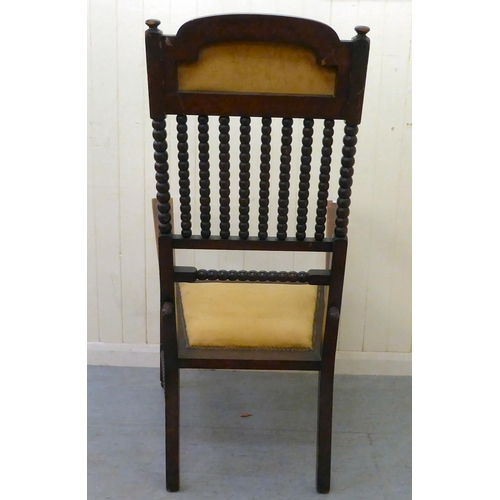 32 - An Arts & Crafts period mahogany and stained beech framed chair with bobbin turned features and ... 