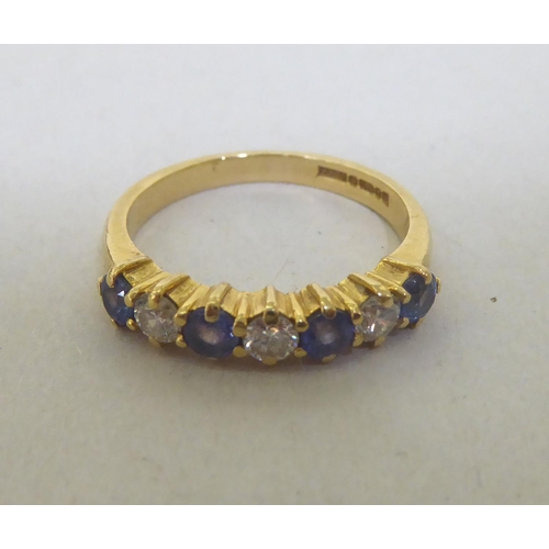 335 - An 18ct gold diamond and sapphire half-eternity ring