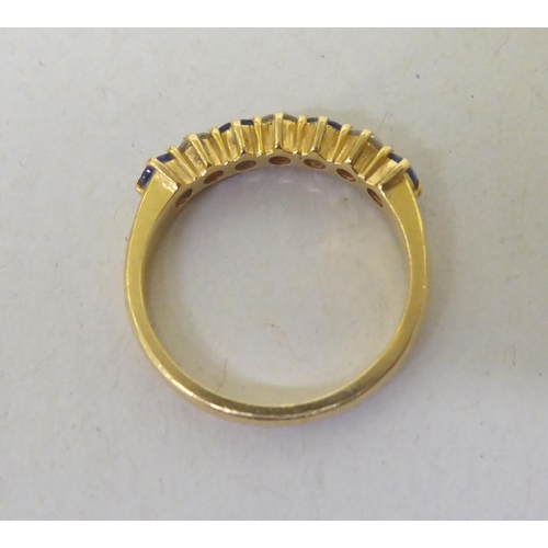 335 - An 18ct gold diamond and sapphire half-eternity ring