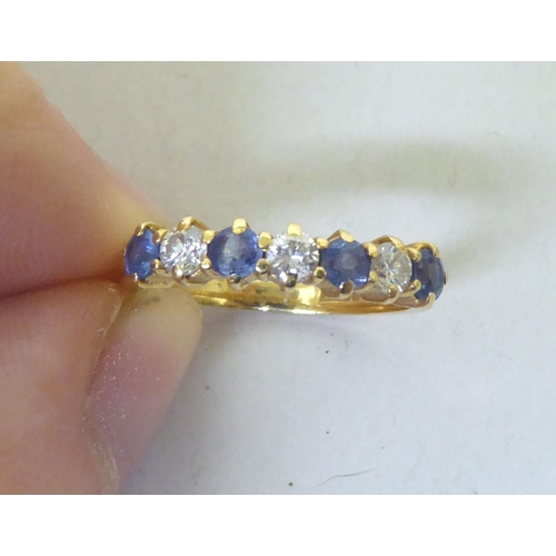 335 - An 18ct gold diamond and sapphire half-eternity ring