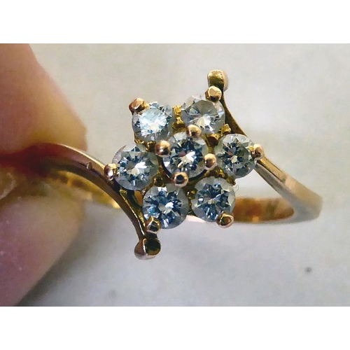 339 - A yellow metal crossover ring, set with white stones