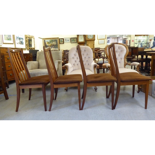 346 - A set of four G-Plan teak framed dining chairs, each with a slatted back and upholstered seat, raise... 