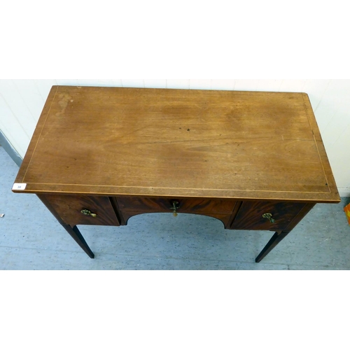 38 - An early 20thC string inlaid mahogany and flame mahogany finished, three drawer kneehole writing des... 