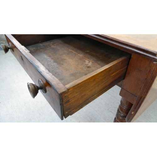 42 - A mid 19thC mahogany Pembroke table, raised on ring turned legs and casters  28