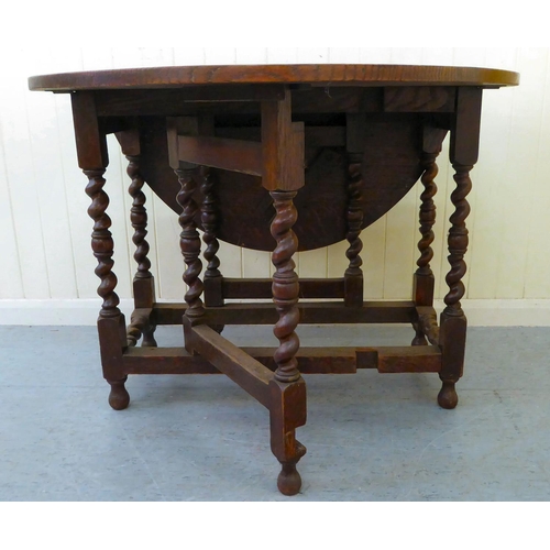 46 - An early 20thC oak gateleg drop-leaf table, raised on barleytwist and block supports  29