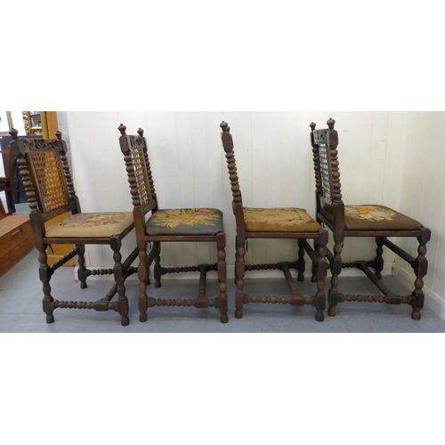 48 - A set of four early/mid 20thC stained, carved and turned, beech framed dining chairs with caned back... 