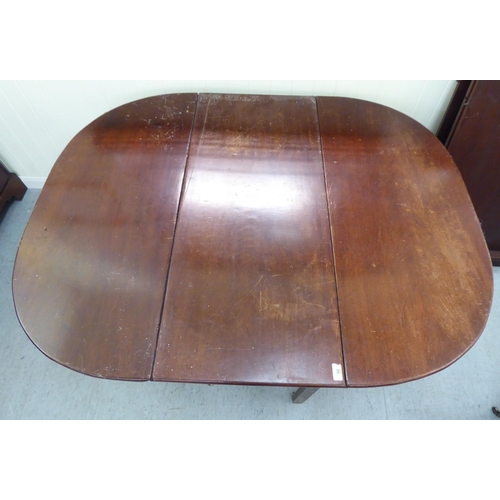 50 - A George III mahogany drop-leaf table, raised on square legs  28