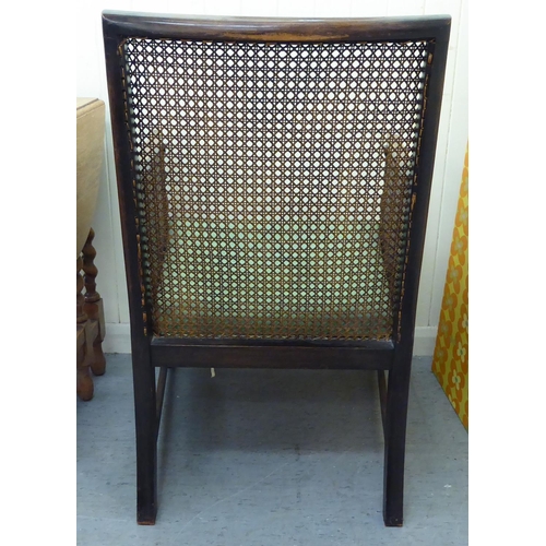 52 - Small furniture: to include an early 20thC mahogany showwood framed bergere chair, raised on turned ... 