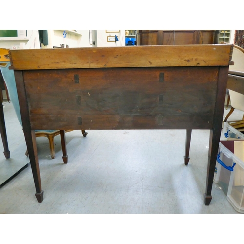 53 - A late Victorian mahogany five drawer kneehole dressing table with a low gallery upstand, raised on ... 