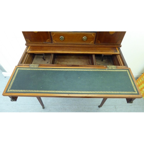 55 - An Edwardian mahogany bureau with a gallery, over an open shelf and drawer, flanked by two cupboard ... 