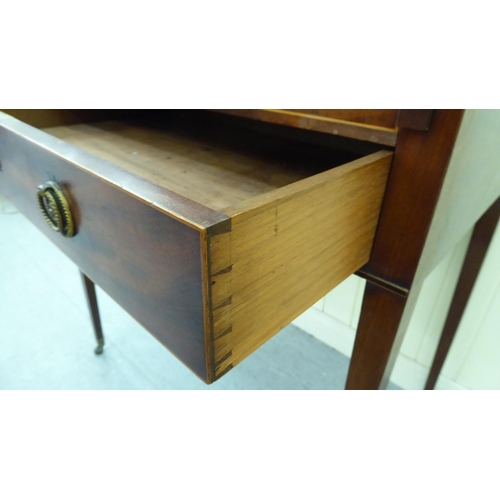 55 - An Edwardian mahogany bureau with a gallery, over an open shelf and drawer, flanked by two cupboard ... 