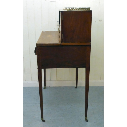 55 - An Edwardian mahogany bureau with a gallery, over an open shelf and drawer, flanked by two cupboard ... 