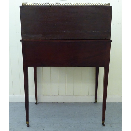 55 - An Edwardian mahogany bureau with a gallery, over an open shelf and drawer, flanked by two cupboard ... 