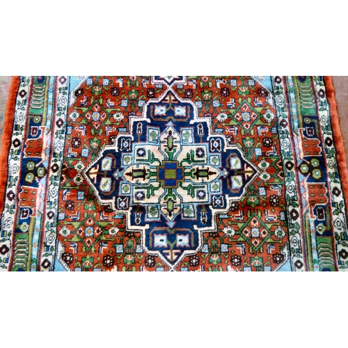 71 - A Persian design rug, decorated with a central medallion, surrounded by birds and geometric patterns... 