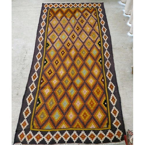 86 - A Kelim design rug, decorated with geometric patterns, on a purple ground  112