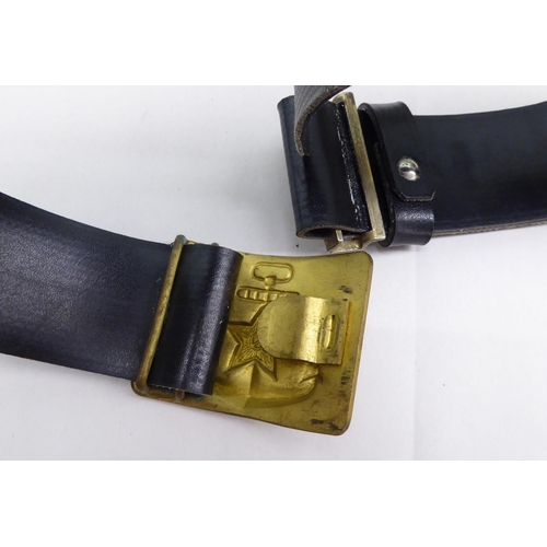 9 - Two military black hide belts with buckles(Please Note: this lot is subject to the statement made in... 