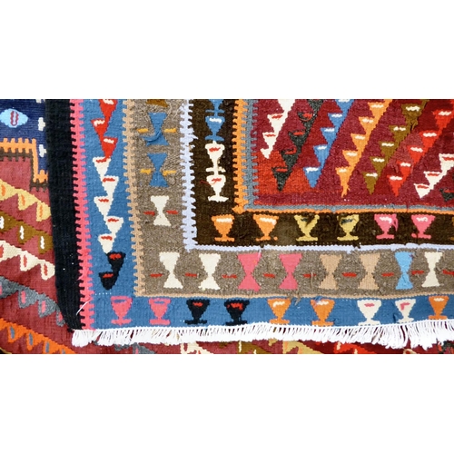 91 - A Kelim design runner, decorated with three central medallions, surrounded by geometric patterns, on... 