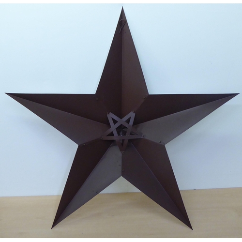 116 - A five point, silver painted, rivetted tinplate Christmas star  20