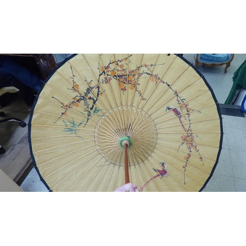 124 - Two 20thC Oriental handpainted paper parasols