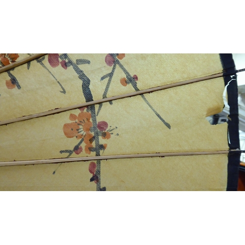 124 - Two 20thC Oriental handpainted paper parasols