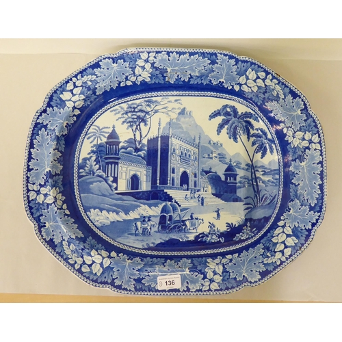 136 - A 19thC earthenware meat dish, decorated in blue and white with landscapes  20