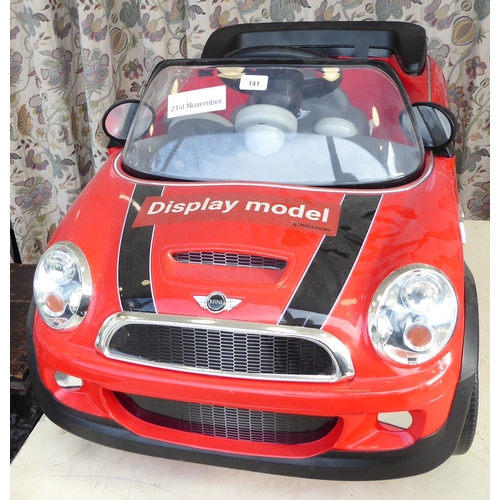 141 - A child's display model only, battery powered replica vehicle, fashioned as a Mini Convertible ... 