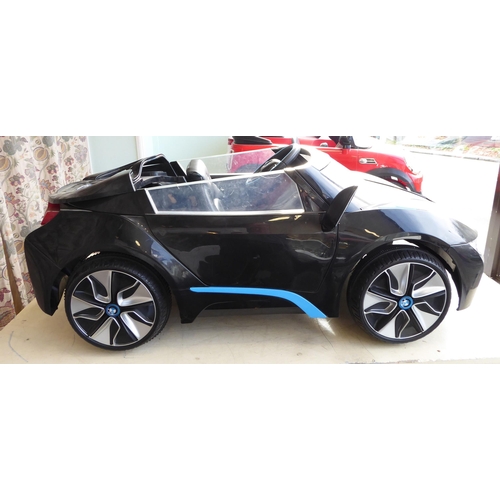 142 - A child's display model only, battery powered replica vehicle, fashioned as a BMW I8 Convertible&nbs... 