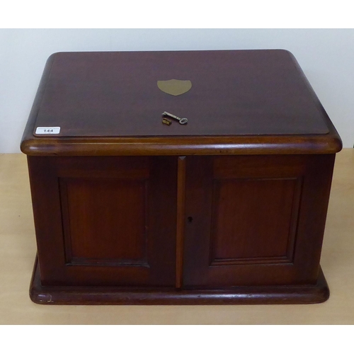 144 - A 20thC mahogany, military design (empty) canteen with panelled doors, enclosing four drawers with p... 