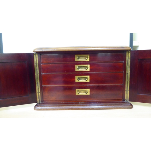 144 - A 20thC mahogany, military design (empty) canteen with panelled doors, enclosing four drawers with p... 