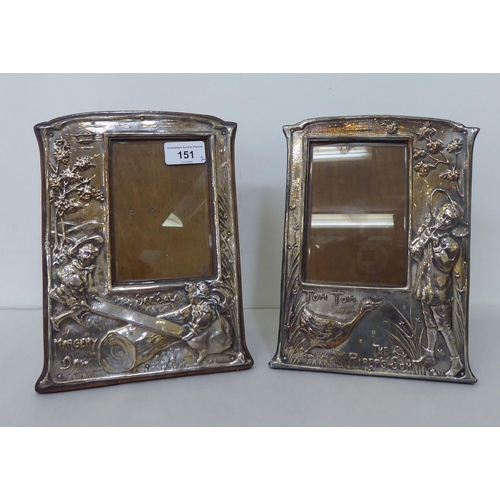 151 - A pair of silver plated photograph frames, the offset glazed apertures in nursery rhyme frames, embo... 