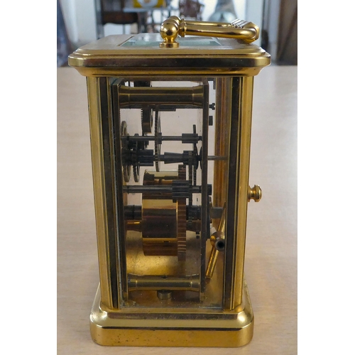 16 - A 20thC lacquered brass and glazed cased carriage timepiece; the movement faced by a Roman dial, ins... 